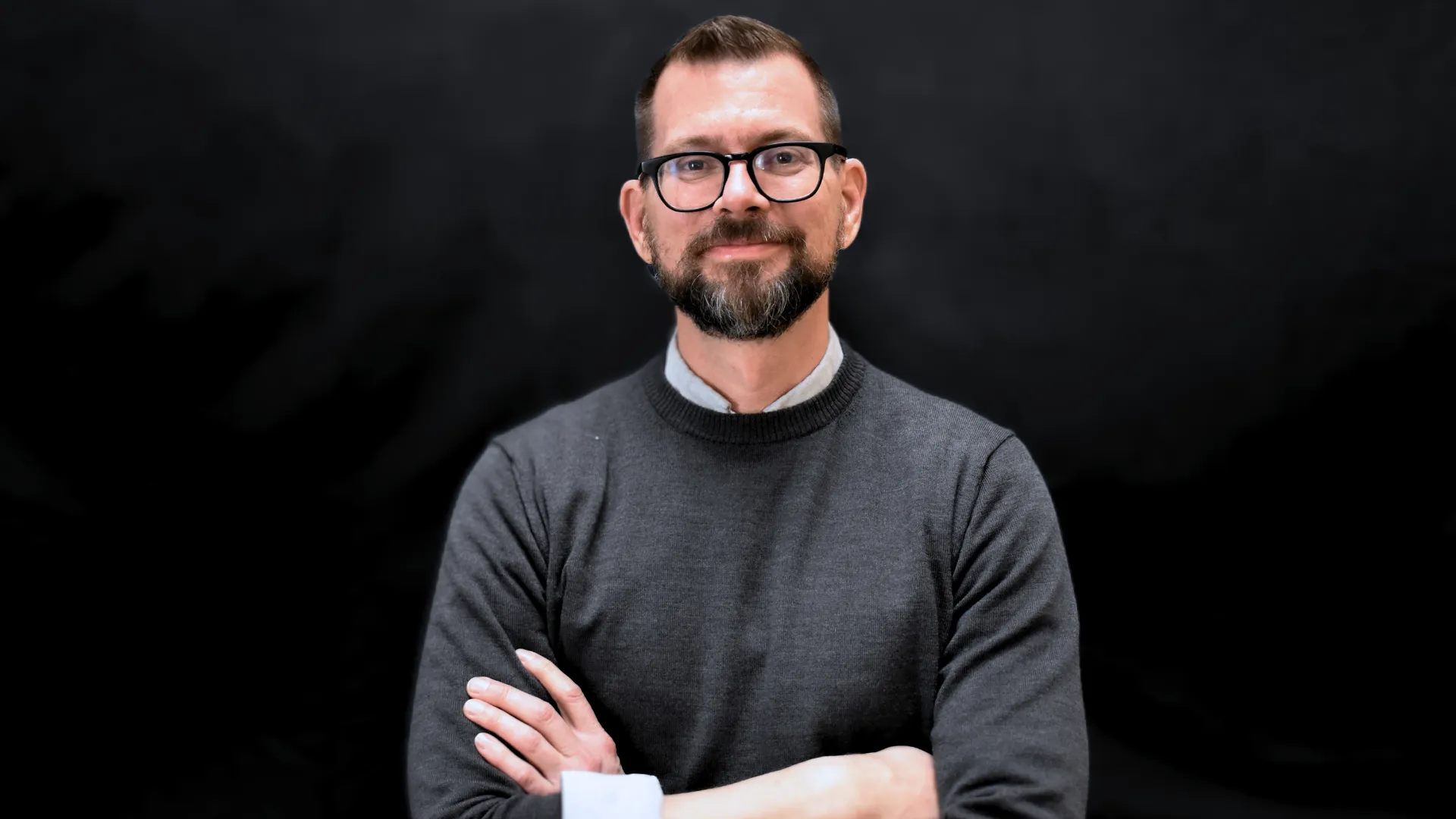 A person sitting at a desk in front of a computer